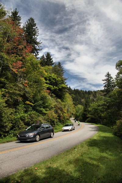 Cars and motorcycles drive the Blue Ridge Parkway near Mount Pisgah.