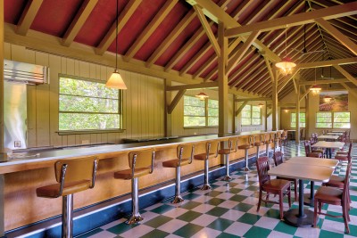 The Bluffs dining room with checkerboard floors and stools along a long lunch counter.