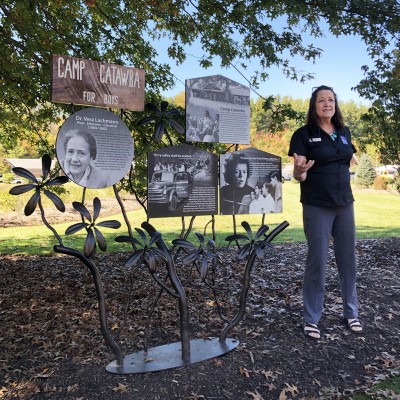 Blue Ridge Parkway Foundation CEO Carolyn Ward with the unveiled Camp Catawba sign.
