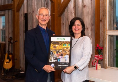 Chris Sieverdes, President of National Scenic Byway Foundation, presents the 2022 Visitor Experience Award to Jordan Calaway, Chief Development Officer of the Blue Ridge Parkway Foundation.