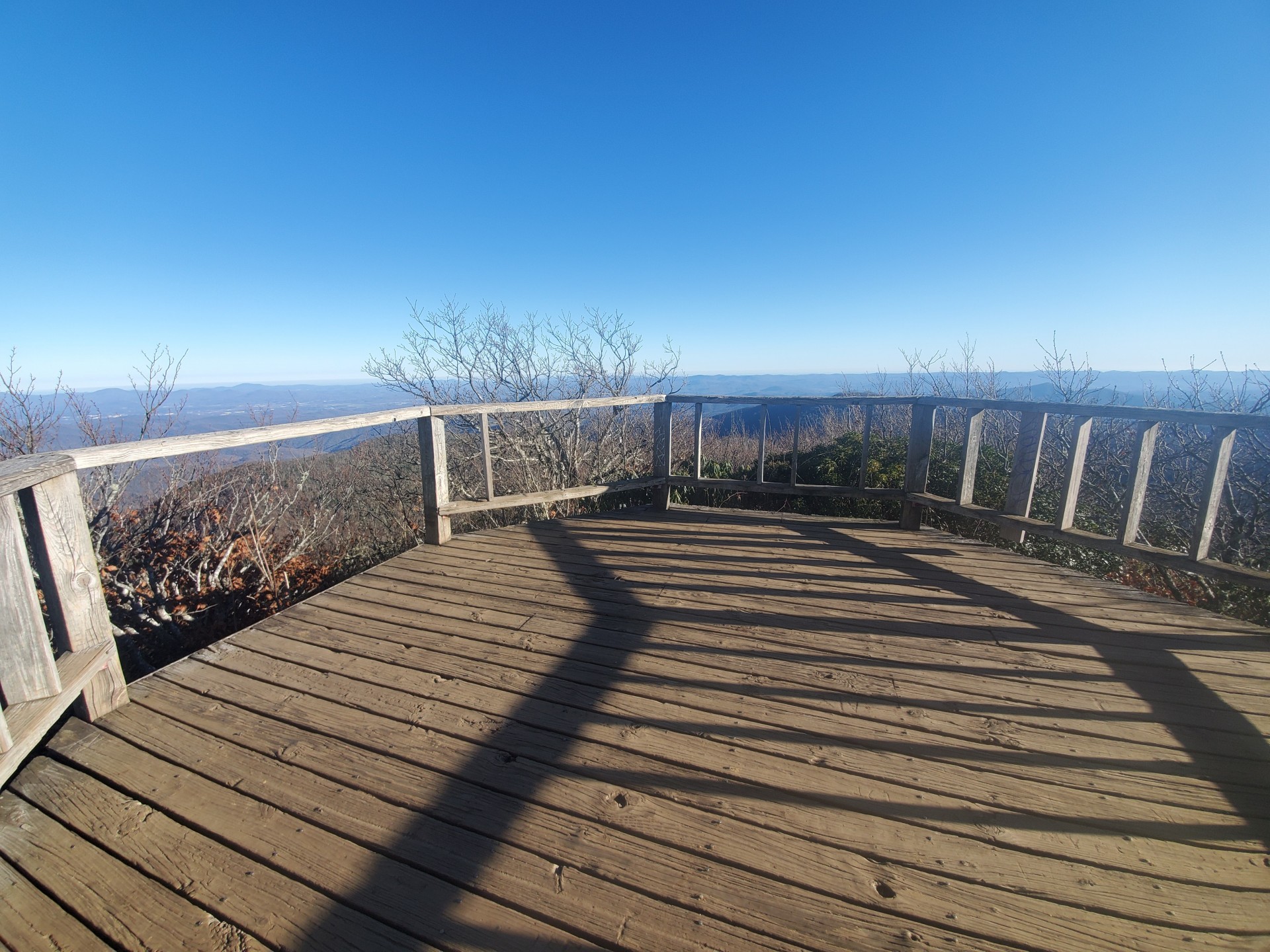 The wide deck of the platform on the Mount Pisgah Trail with a view of the mountains in the distance
