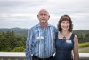 Ken and Christine Castelloe pose with a mountain background.