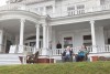 Guests enjoy drinks on the front lawn at Flat Top Manor.
