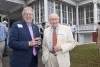 N.C. Rep. Ray Russell and Tom Fisher with wine glasses in front of Flat Top Manor.