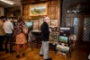 Guests admire art in the ballroom during the opening gala for the art show Of Valley & Ridge on October 26 at Zealandia in Asheville.